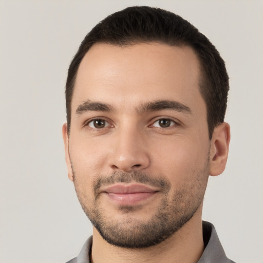 Joyful white young-adult male with short  black hair and brown eyes