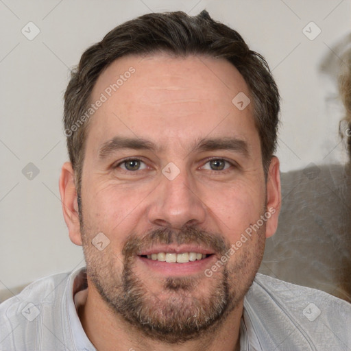 Joyful white adult male with short  brown hair and brown eyes