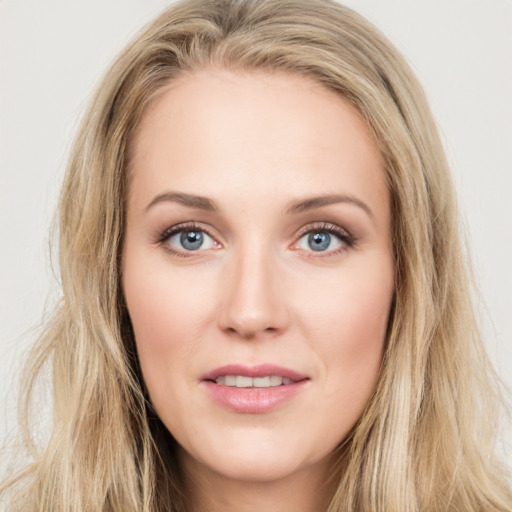 Joyful white young-adult female with long  brown hair and blue eyes