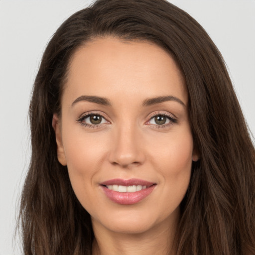 Joyful white young-adult female with long  brown hair and brown eyes