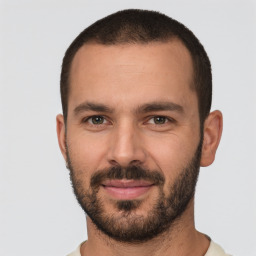 Joyful white young-adult male with short  black hair and brown eyes