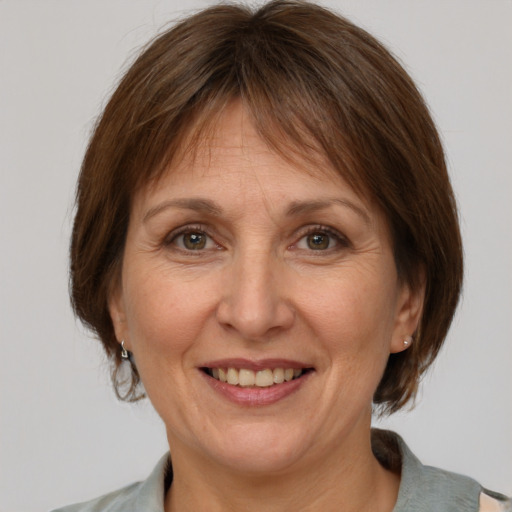 Joyful white adult female with medium  brown hair and grey eyes