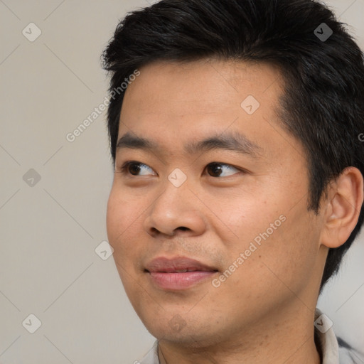 Joyful asian young-adult male with short  black hair and brown eyes