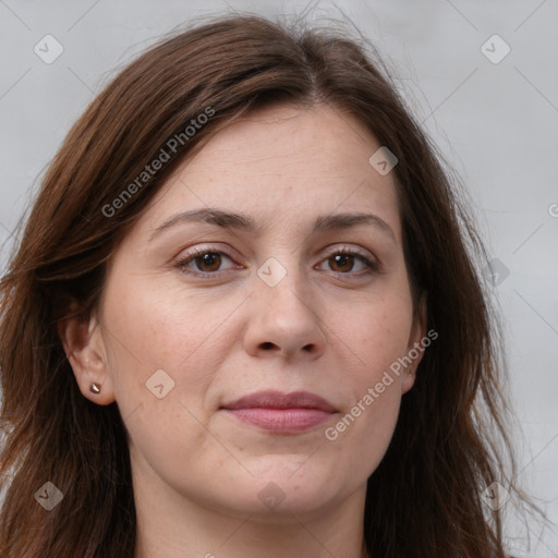 Joyful white adult female with long  brown hair and brown eyes