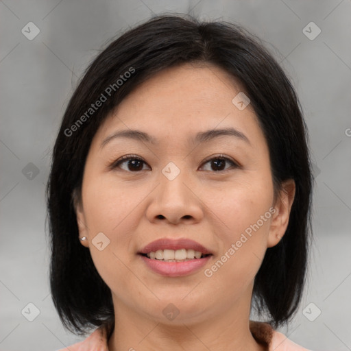 Joyful asian adult female with medium  brown hair and brown eyes