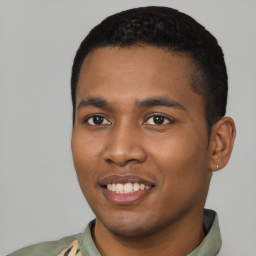 Joyful black young-adult male with short  black hair and brown eyes