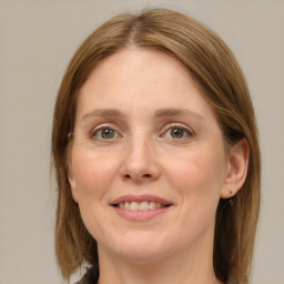 Joyful white young-adult female with medium  brown hair and green eyes