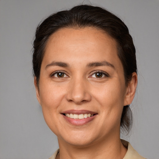 Joyful white adult female with medium  brown hair and brown eyes