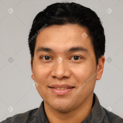 Joyful latino young-adult male with short  black hair and brown eyes