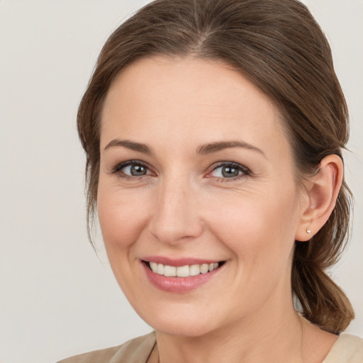 Joyful white young-adult female with medium  brown hair and brown eyes