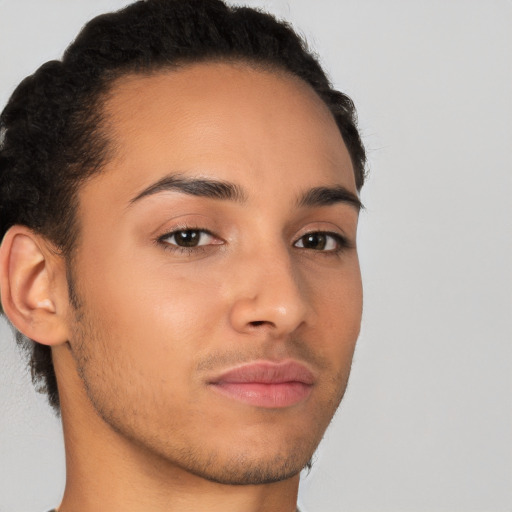 Joyful latino young-adult male with short  brown hair and brown eyes