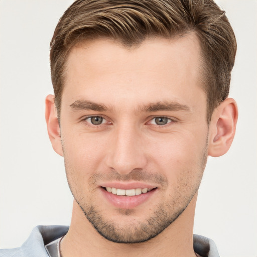 Joyful white young-adult male with short  brown hair and grey eyes