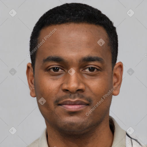 Joyful black young-adult male with short  black hair and brown eyes