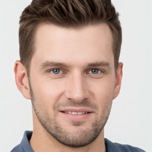 Joyful white young-adult male with short  brown hair and grey eyes