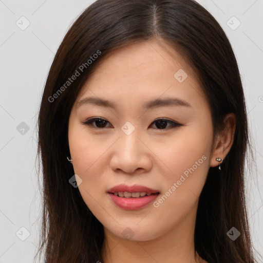 Joyful asian young-adult female with long  brown hair and brown eyes