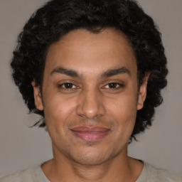 Joyful latino young-adult male with short  brown hair and brown eyes