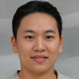 Joyful asian young-adult male with short  brown hair and brown eyes