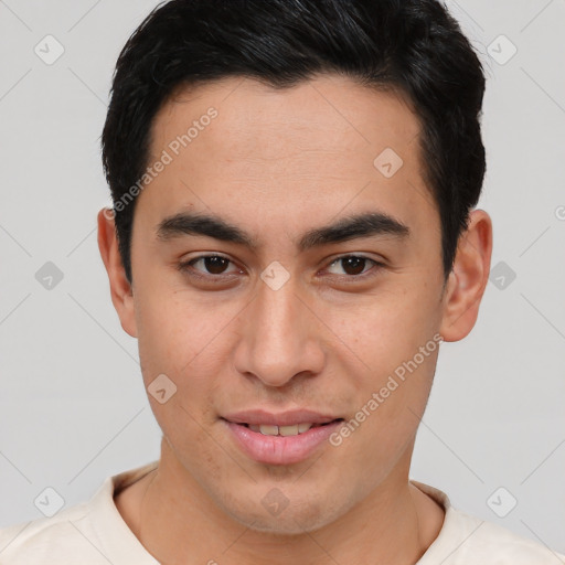 Joyful asian young-adult male with short  brown hair and brown eyes