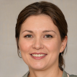 Joyful white adult female with medium  brown hair and brown eyes