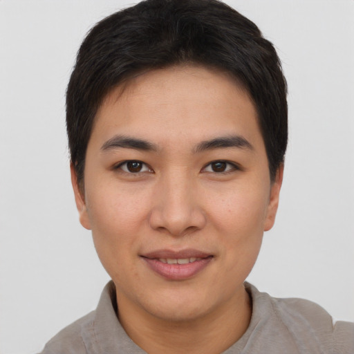Joyful asian young-adult female with short  brown hair and brown eyes