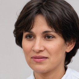 Joyful white adult female with medium  brown hair and brown eyes