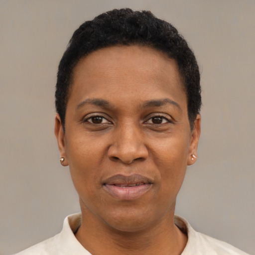 Joyful black adult female with short  black hair and brown eyes
