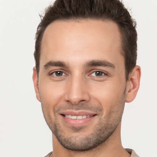 Joyful white young-adult male with short  brown hair and brown eyes