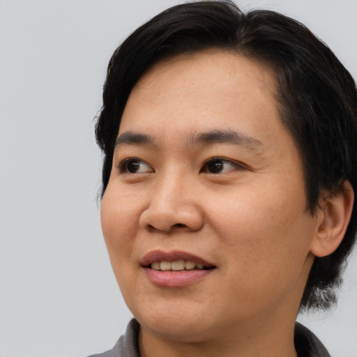 Joyful asian young-adult female with medium  black hair and brown eyes