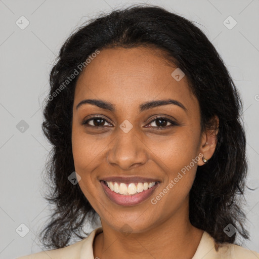 Joyful black young-adult female with long  brown hair and brown eyes