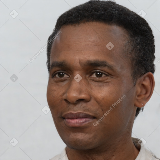 Joyful black adult male with short  black hair and brown eyes