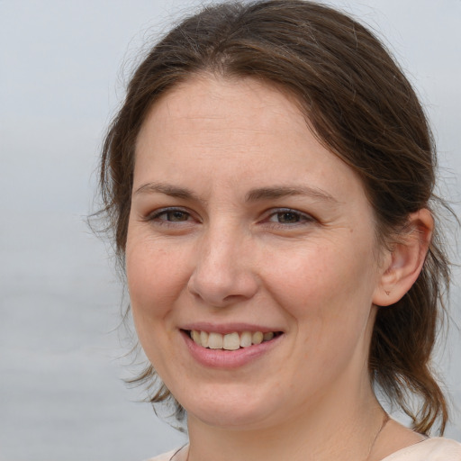 Joyful white adult female with medium  brown hair and brown eyes