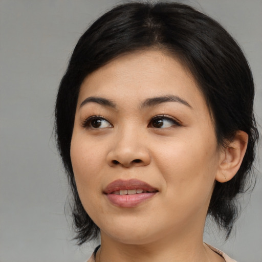 Joyful asian young-adult female with medium  black hair and brown eyes