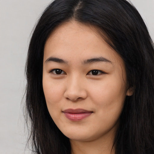 Joyful asian young-adult female with long  black hair and brown eyes