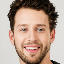 Joyful white young-adult male with short  brown hair and blue eyes