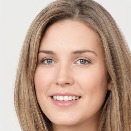 Joyful white young-adult female with long  brown hair and green eyes