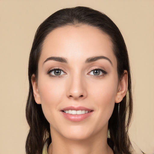 Joyful white young-adult female with long  brown hair and brown eyes