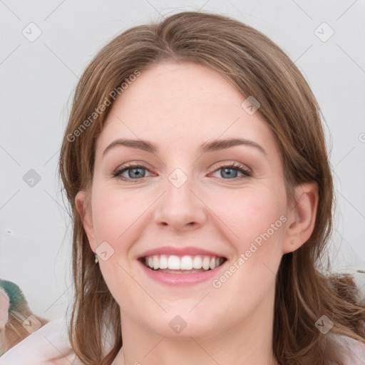 Joyful white young-adult female with medium  brown hair and green eyes