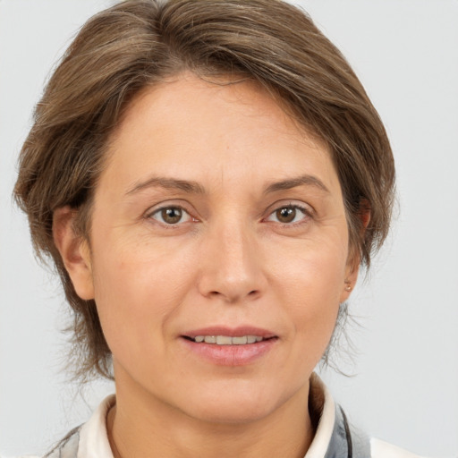 Joyful white adult female with medium  brown hair and brown eyes