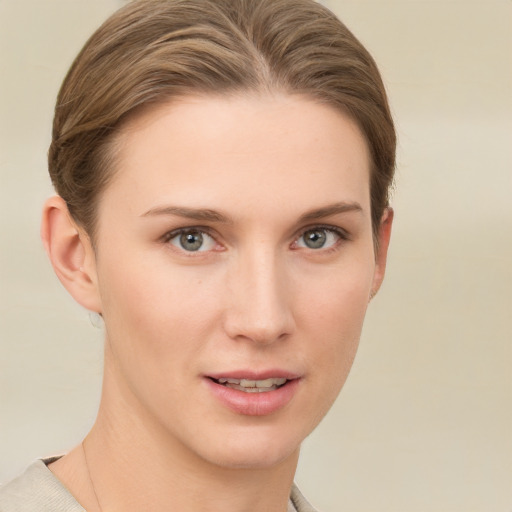 Joyful white young-adult female with short  brown hair and grey eyes