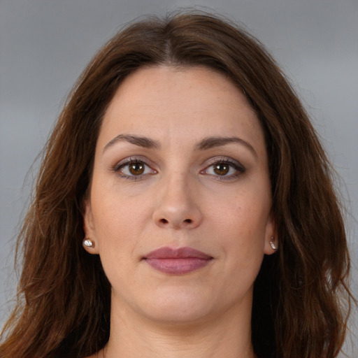 Joyful white adult female with long  brown hair and brown eyes