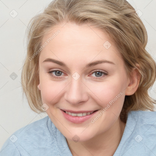 Joyful white young-adult female with medium  brown hair and blue eyes