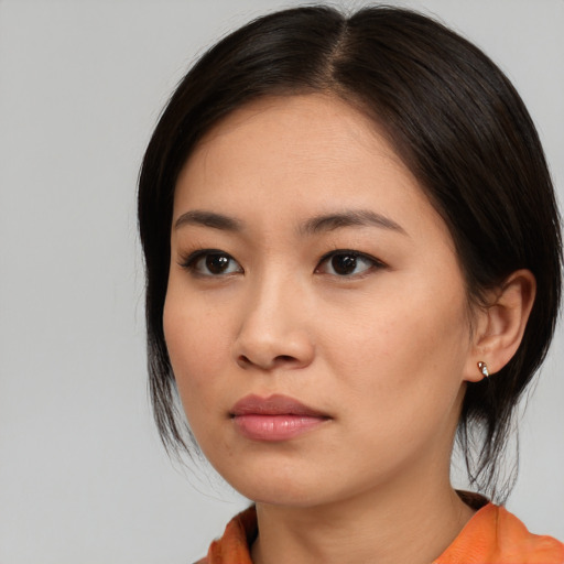 Neutral asian young-adult female with medium  brown hair and brown eyes