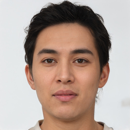 Joyful asian young-adult male with short  brown hair and brown eyes