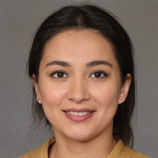 Joyful latino young-adult female with medium  brown hair and brown eyes