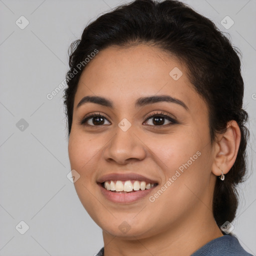 Joyful latino young-adult female with long  brown hair and brown eyes