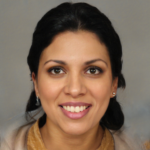 Joyful latino young-adult female with long  black hair and brown eyes