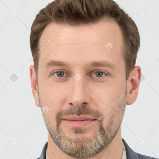 Joyful white adult male with short  brown hair and grey eyes