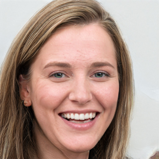 Joyful white young-adult female with long  brown hair and blue eyes