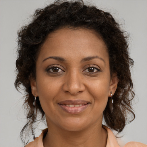Joyful black young-adult female with medium  brown hair and brown eyes