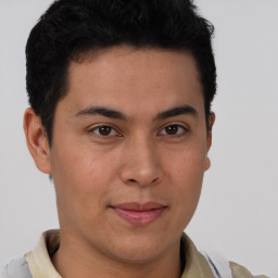 Joyful latino young-adult male with short  brown hair and brown eyes